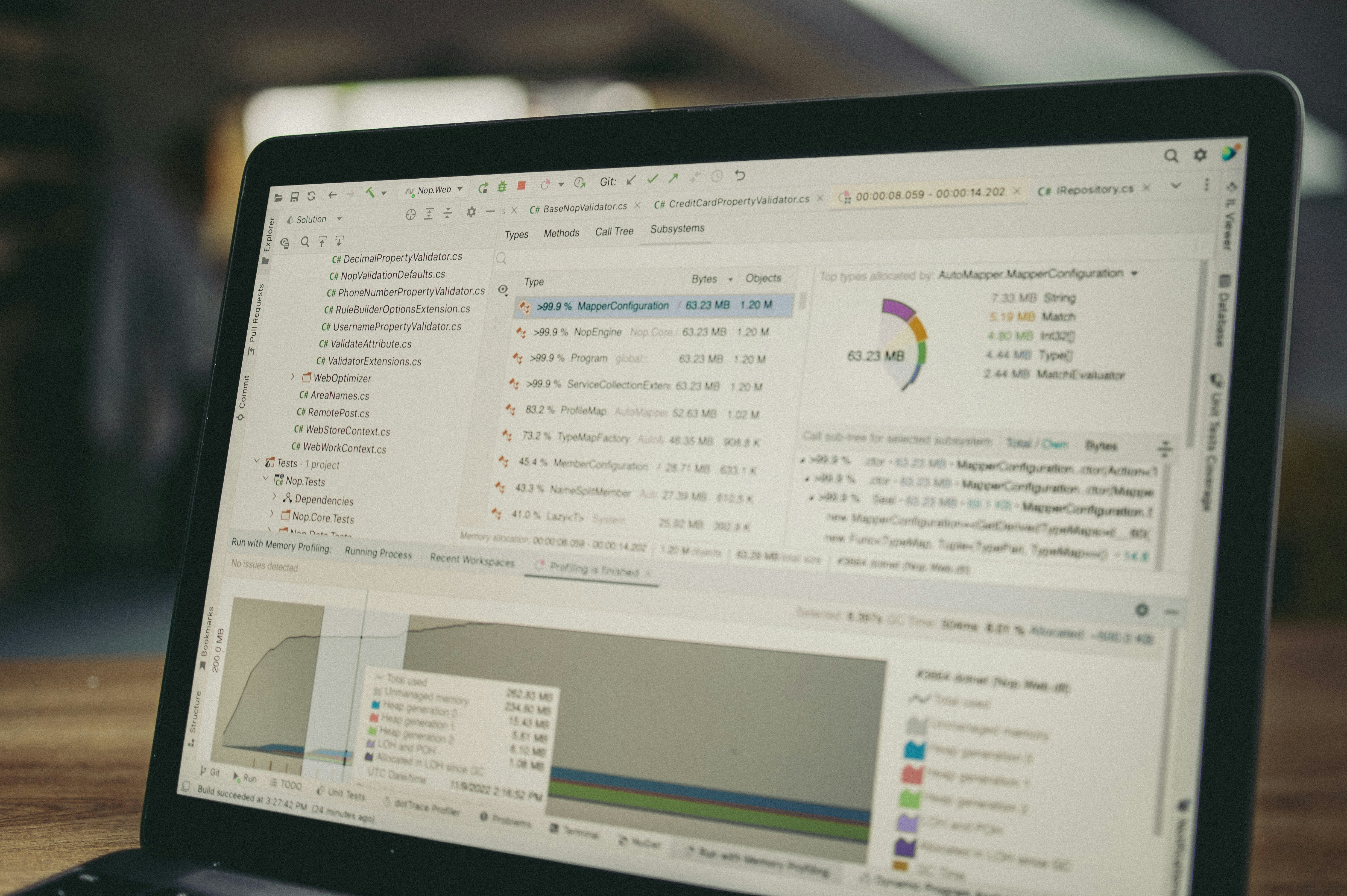 Laptop displaying code and data charts