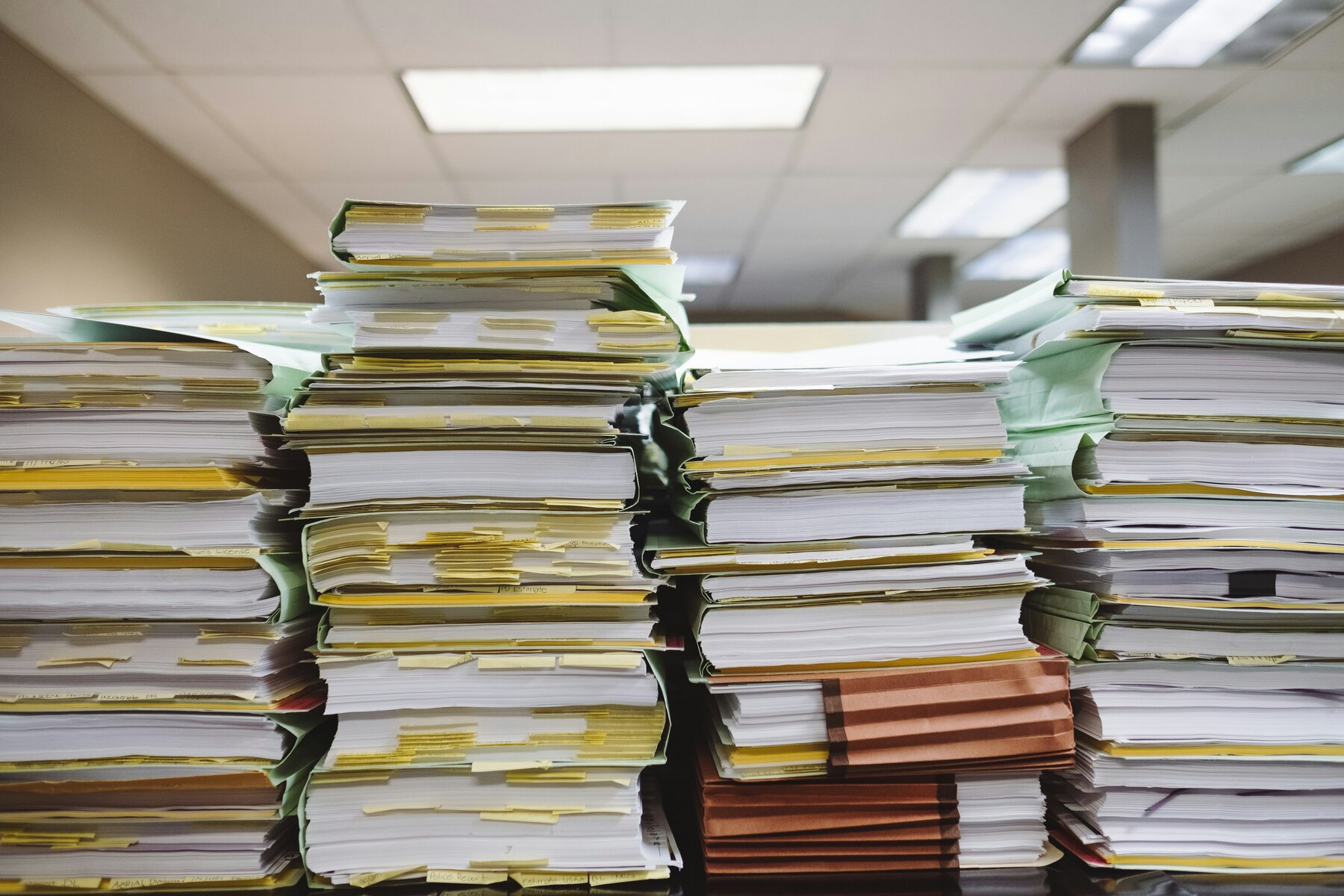 Stacks of paper records and folders in an office
