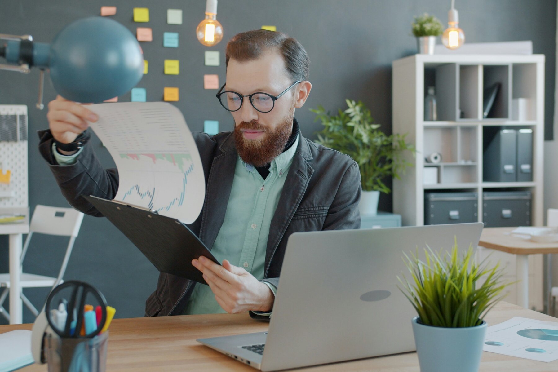 Person reviewing a printed report at a desk
