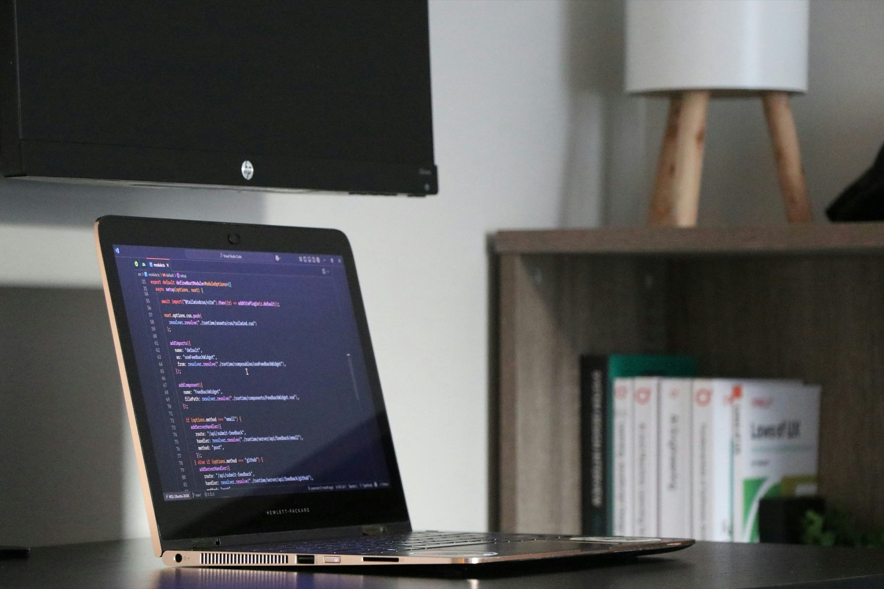 Laptop displaying code on a desk