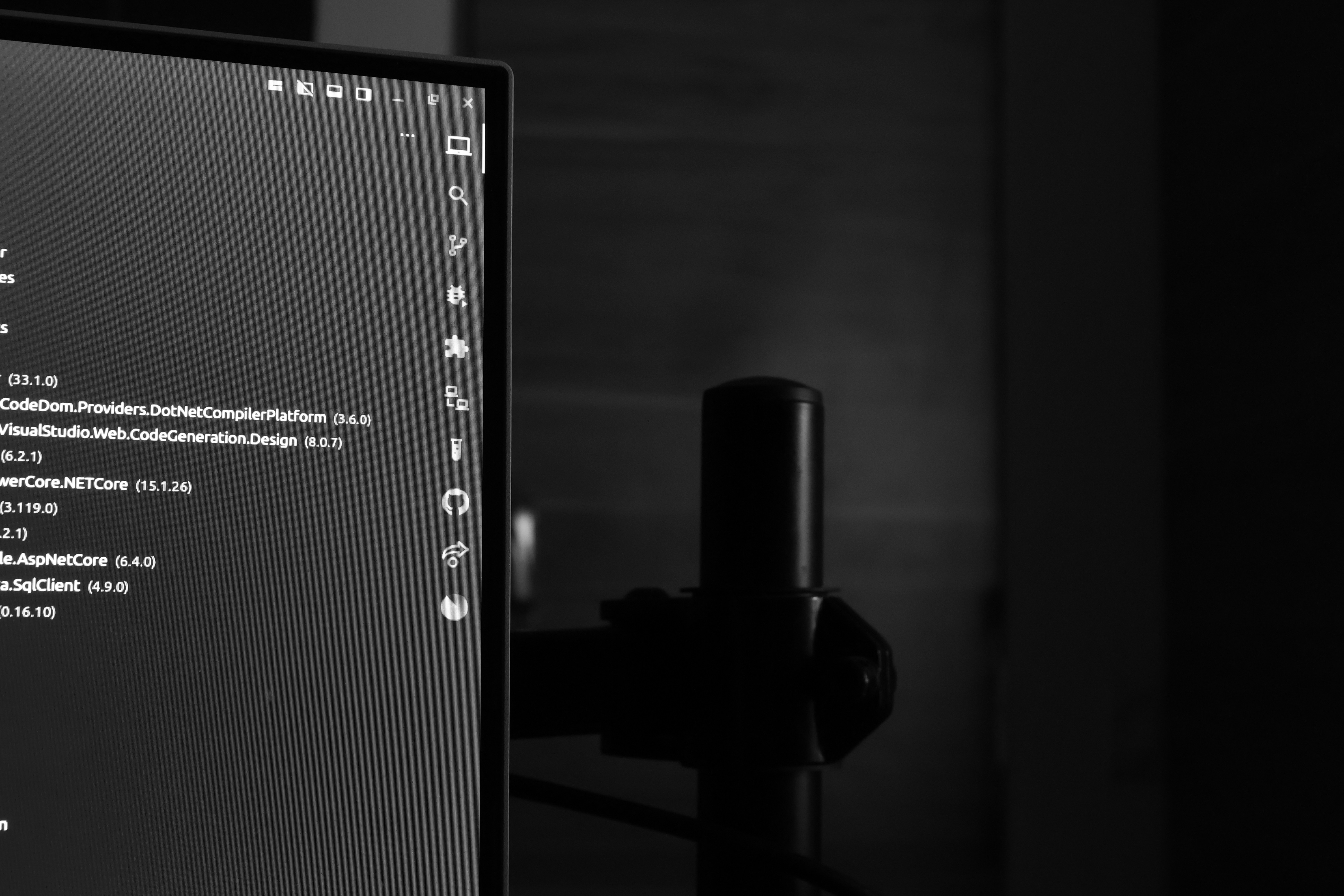 Computer monitor displaying code in a dark room